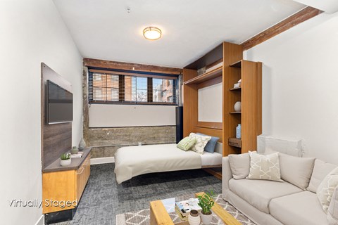 A living room with a white couch and a television.